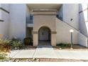 Condo building exterior with arched entryway and landscaping at 3150 Soft Breezes Dr # 2030, Las Vegas, NV 89128