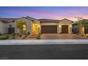 Single-story home with three-car garage, illuminated at dusk at 349 Agnew St, Las Vegas, NV 89138