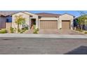 Single-story house with three-car garage and well-manicured landscaping at 349 Agnew St, Las Vegas, NV 89138