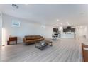 Open living room with light gray vinyl flooring and access to backyard at 3540 Valley Lily St, North Las Vegas, NV 89032