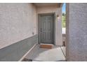 Gray front door with a small mat, located on a light-colored walkway at 4439 Yellow Harbor St, Las Vegas, NV 89129