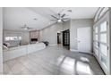 Spacious living room with light gray tile floors and a fireplace at 4620 Clay Peak Dr, Las Vegas, NV 89129