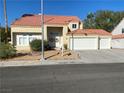 Two-story house with tile roof, attached two-car garage, and drought-tolerant landscaping at 503 Lariat Ln, Henderson, NV 89014