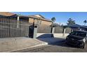 Side view of the house showcasing its brick exterior and fence at 5162 Woodruff Pl, Las Vegas, NV 89120