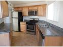 Galley kitchen with granite countertops and stainless steel appliances at 5175 Orinda Ave, Las Vegas, NV 89120