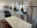 Modern kitchen with white cabinets, quartz countertops, and stainless steel appliances at 5640 Judith Resnik Ct, Las Vegas, NV 89103