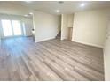 Open living area with gray vinyl flooring and kitchen views at 6124 Jones Cir, Las Vegas, NV 89107