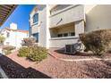 Small condo patio with gravel landscaping and AC unit at 698 S Racetrack Rd # 711, Henderson, NV 89015