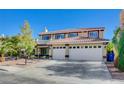 Two-story house with a three-car garage and a landscaped front yard, featuring a pool at 7978 Coronado Coast St, Las Vegas, NV 89139