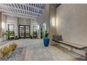 Elegant courtyard entry with a pergola, seating area, and water feature at 8104 Via Del Cerro Ct, Las Vegas, NV 89117