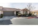 Single-story home with attached garage and neatly landscaped front yard at 8634 Lakota St, Las Vegas, NV 89123