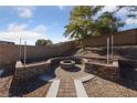 Backyard fire pit with brick border and raised garden beds at 10229 Angels Loft St, Las Vegas, NV 89131