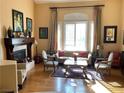Spacious living room with hardwood floors, fireplace, and large windows at 2438 Ping Drive, Henderson, NV 89074