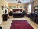 Large main bedroom with a dark wood bedroom set and red carpet at 2438 Ping Drive, Henderson, NV 89074
