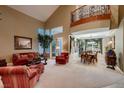 Bright and airy living room with vaulted ceilings and elegant decor, leading into the dining area at 3042 Hammerwood Dr, Las Vegas, NV 89135