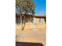 Tan colored building exterior with a tree and walkway at 3801 Daisy St # 42, Las Vegas, NV 89119