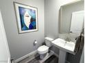 Elegant powder room with pedestal sink and art at 498 Granite Arch St, Las Vegas, NV 89138