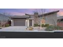 Contemporary home exterior with a two-car garage, modern landscaping, and inviting entrance at 6056 Willow Rock St, Las Vegas, NV 89135