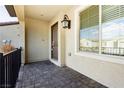Covered patio with brick flooring, a door and window with blinds at 675 Omaggio Pl, Henderson, NV 89011