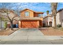 This home features an attached garage, desert landscaping, terracotta stucco, double-door entry, and lush mature trees at 6921 Wineberry Dr, Las Vegas, NV 89119