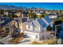 Two-story house with gray roof, mountain views at 10332 Splendor Ridge Ave, Las Vegas, NV 89135