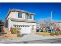 Two-story house with attached garage and landscaped front yard at 10332 Splendor Ridge Ave, Las Vegas, NV 89135