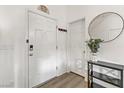 Bright entryway with white door, wood-look floors, and a small table at 165 Arrow Point Ln, Henderson, NV 89011