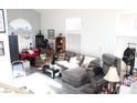 Spacious living room with a gray sectional sofa and lots of natural light at 1764 Sunflower Ct, Henderson, NV 89074