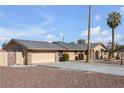 Single-story home with tan exterior, attached garage, and desert landscaping at 2000 Goldhill Ave, Las Vegas, NV 89106