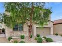 Two-story house with stone accents, a two-car garage, and a landscaped front yard at 201 White Mule Ave, Las Vegas, NV 89148