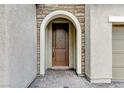 Elegant front door with stone archway and a brick pathway at 201 White Mule Ave, Las Vegas, NV 89148