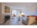 Living room with sectional sofa, fireplace, and wood-look floors at 2200 S Fort Apache Rd # 1065, Las Vegas, NV 89117