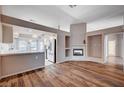 Open living room with wood-look floors and a fireplace at 2214 Sexton Ave, North Las Vegas, NV 89031