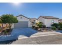 Single-story house featuring a gray garage door and well-maintained landscaping at 2429 Anderson Park Dr, Henderson, NV 89044