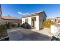 Charming single-story home with a concrete yard and white exterior at 2429 Anderson Park Dr, Henderson, NV 89044