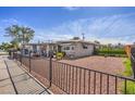 Ranch style home with a fenced yard and mature trees at 309 Wisteria Ave, Las Vegas, NV 89107