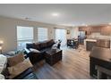 Open living room and kitchen with hardwood floors at 315 Bay Village Pl, Henderson, NV 89011