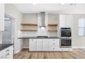 White shaker cabinets, stainless steel appliances, and floating shelves at 315 Rhiannon Ct, Las Vegas, NV 89183