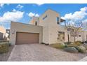 Contemporary home with a large brown garage door and paved driveway at 4302 Swift St, Las Vegas, NV 89135