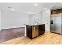 Open concept kitchen and living area with wood-look flooring at 4543 Pencester St, Las Vegas, NV 89115