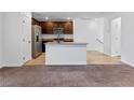 Open concept kitchen and living area with wood-look flooring at 4543 Pencester St, Las Vegas, NV 89115