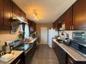 Functional kitchen featuring wooden cabinets and stainless steel appliances including a stove at 4559 S Nellis Blvd, Las Vegas, NV 89121