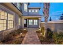 Elegant front entrance with walkway, landscaping, and lighting at 6004 Chessington Ave, Las Vegas, NV 89131