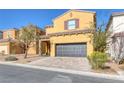 Two-story house with a two-car garage and landscaped front yard at 634 Wounded Star Ave, Las Vegas, NV 89178