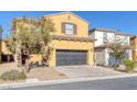 Two-story house with a two-car garage and landscaped front yard at 634 Wounded Star Ave, Las Vegas, NV 89178