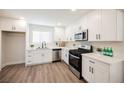 Modern kitchen with white cabinets and stainless steel appliances at 6750 Laronda Ln, Las Vegas, NV 89156