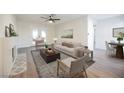 Bright living room with hardwood floors, comfortable seating, and a fireplace at 6750 Laronda Ln, Las Vegas, NV 89156