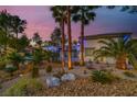 Landscaped front yard with palm trees and drought-tolerant plants at 7436 Oak Grove Ave, Las Vegas, NV 89117