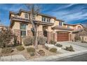 Two-story house with stone accents and desert landscaping at 7700 Tierra Montanosa Ave, Las Vegas, NV 89179