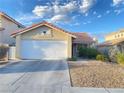 Single-story home with a two-car garage and desert landscaping at 7732 Beverly Hills Dr, Las Vegas, NV 89147